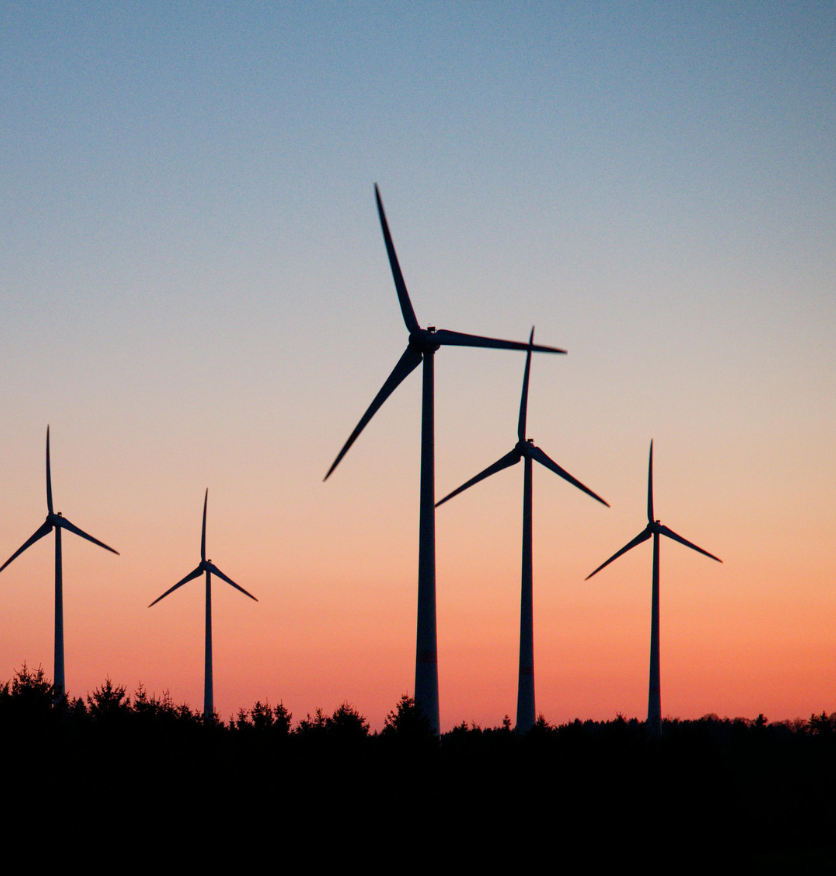 Wind turbines silhouetted at sunset